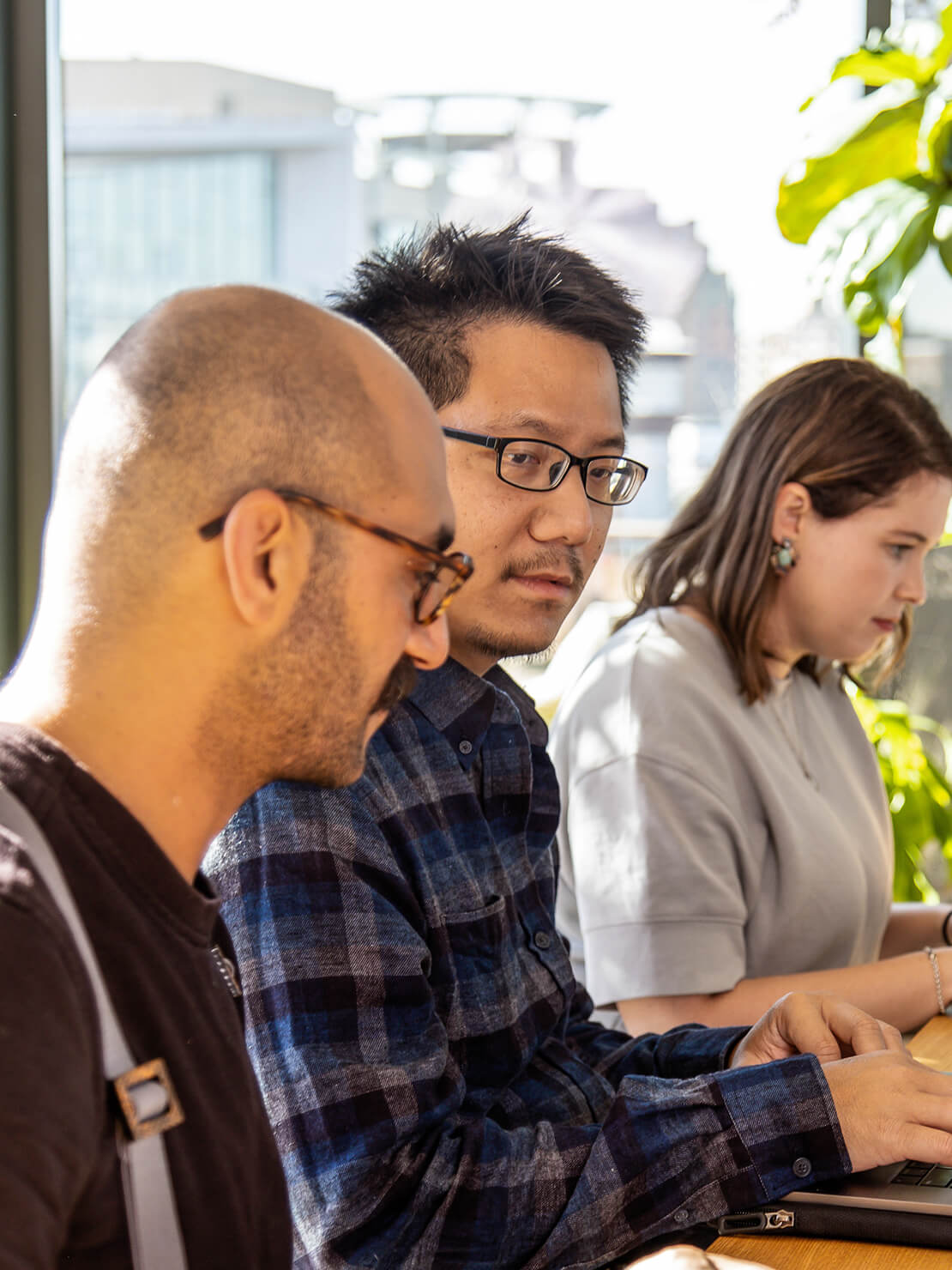 Three people working together at a table. 