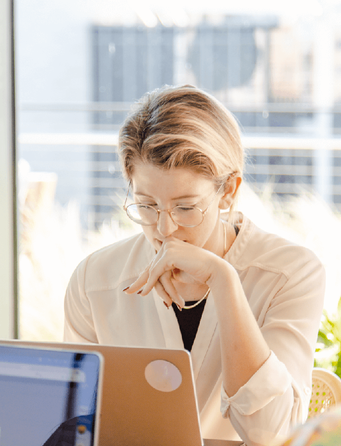 Person staring intently at a computer screen 