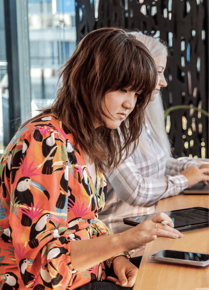 Woman on a phone and tablet.